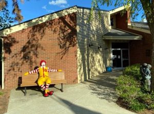Ronald McDonald on a bench